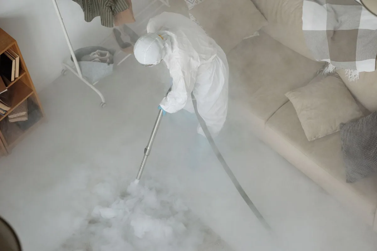 Biohazard cleanup technician in protective equipment, Decatur, AR